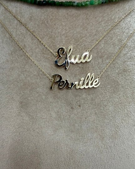 Two gold name necklaces in script lettering