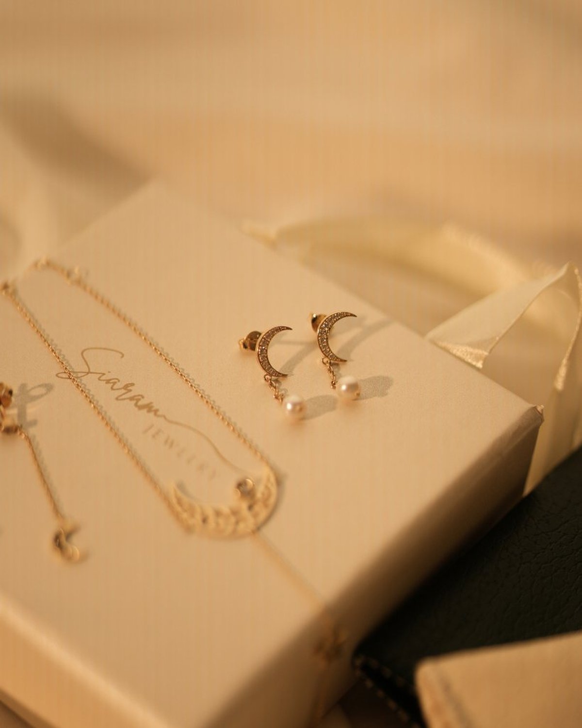 Gold crescent moon earrings with pearl drops