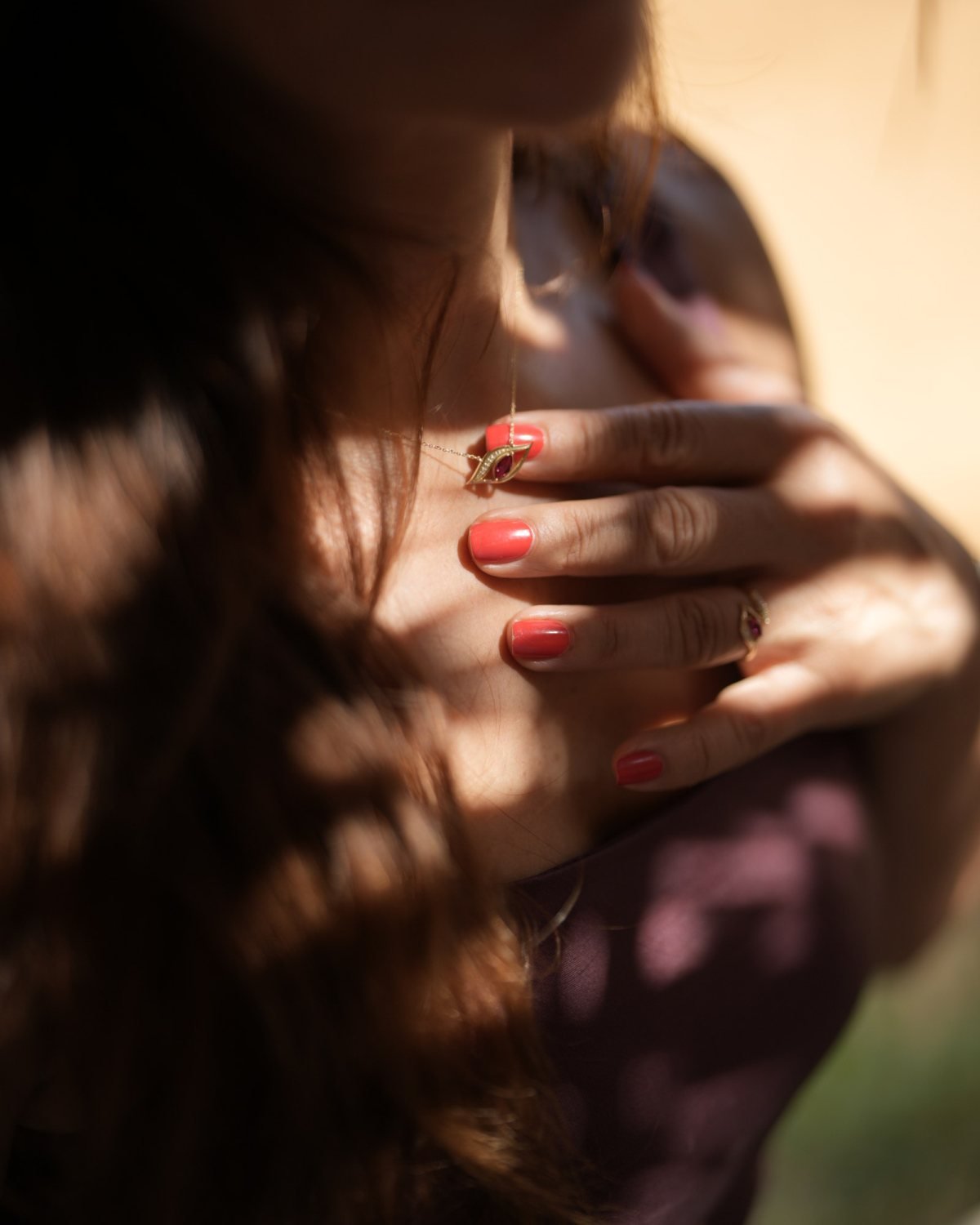Gold horse eye necklace worn in dappled light